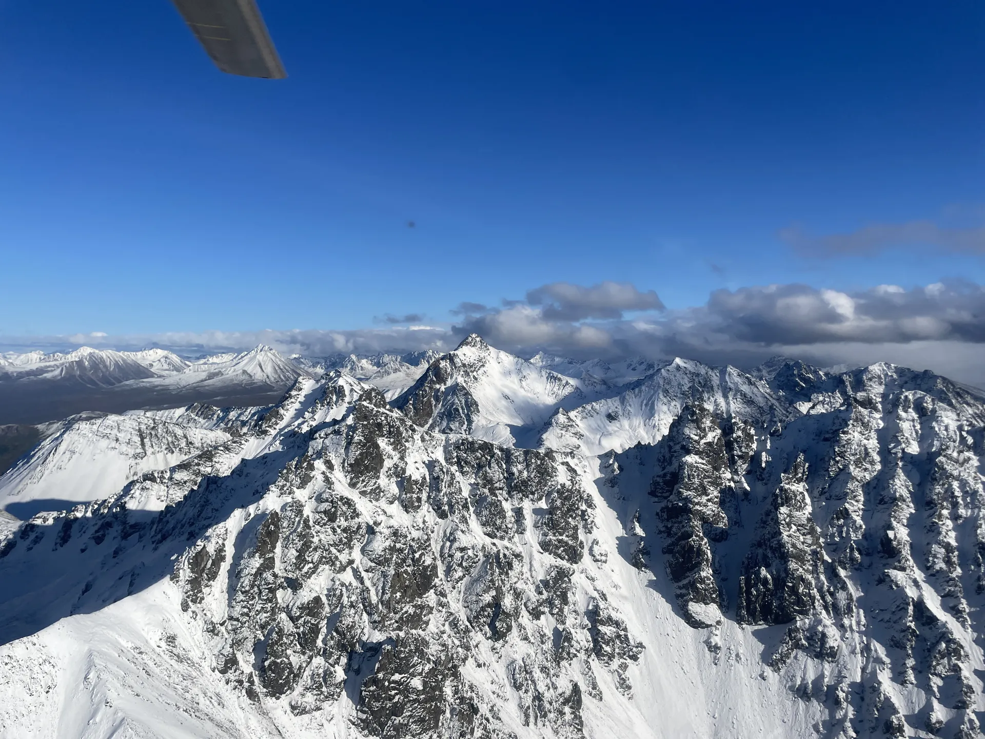Snow-covered mountain peaks seen from a helicopter